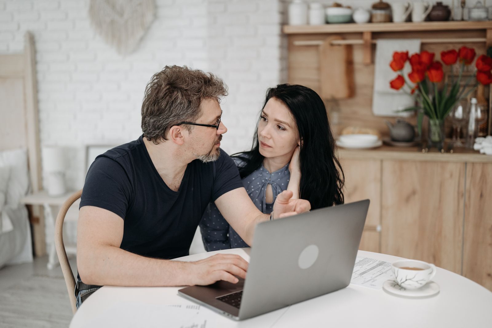 Couple planning a trip on a laptop