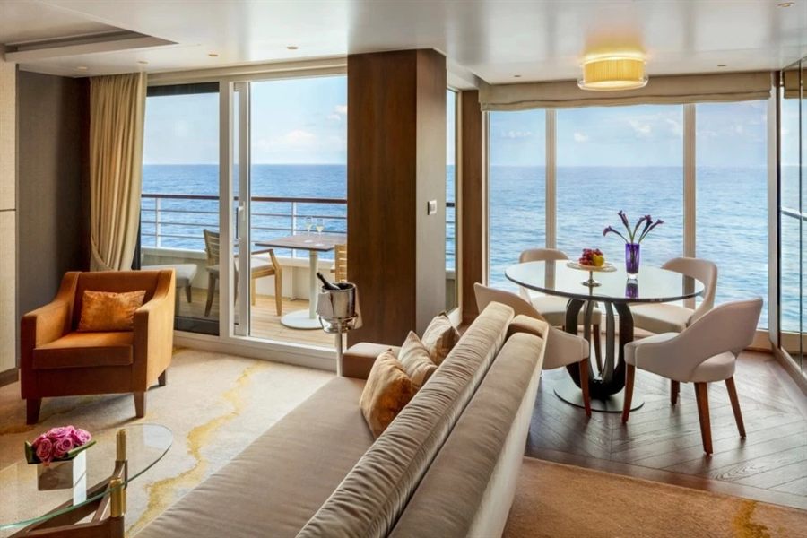 Cruise ship suite lounge with balcony windows